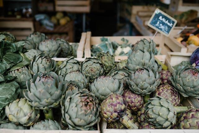 Fresh artichokes for sale at a European street market stall